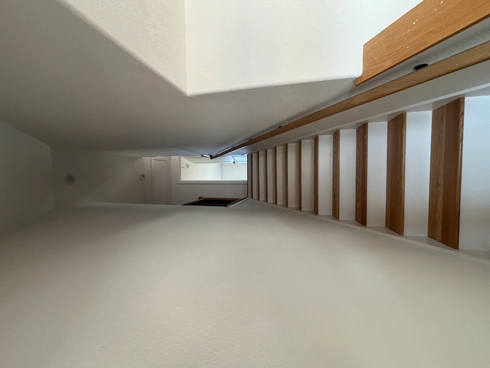 Finished drywall installation with wood framing, ceiling soffit, and prepared surfaces ready for paint
