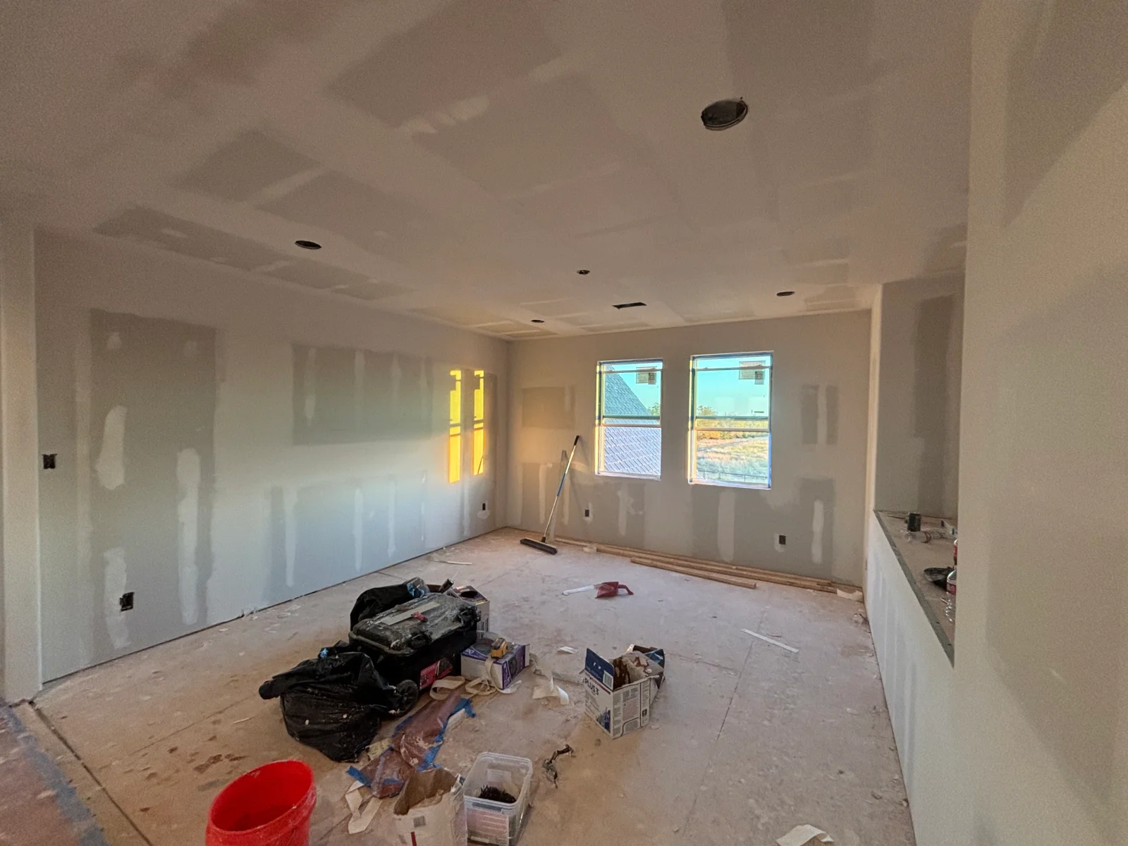 Interior room with finished drywall, recessed lighting, and primed walls ready for painting